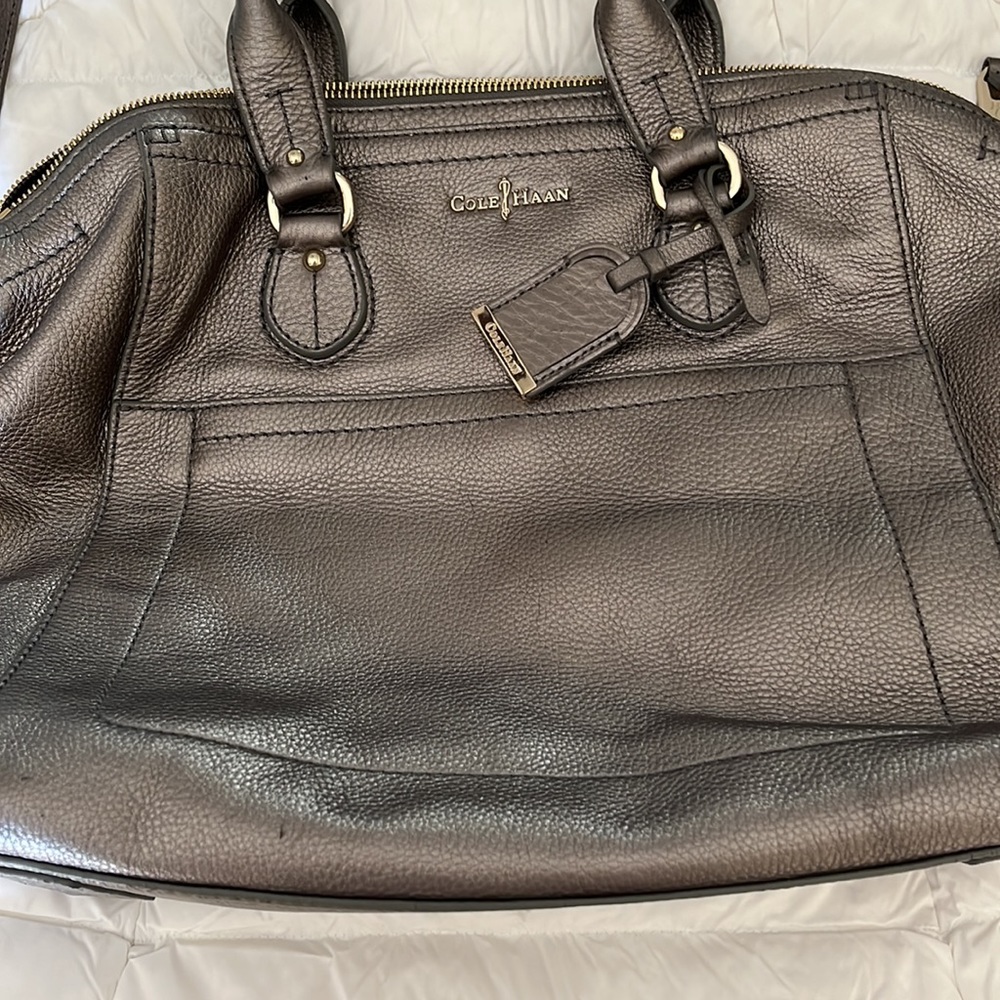 Pewter leather Cole Haan bag.  Top handles along with roughly 3ft strap